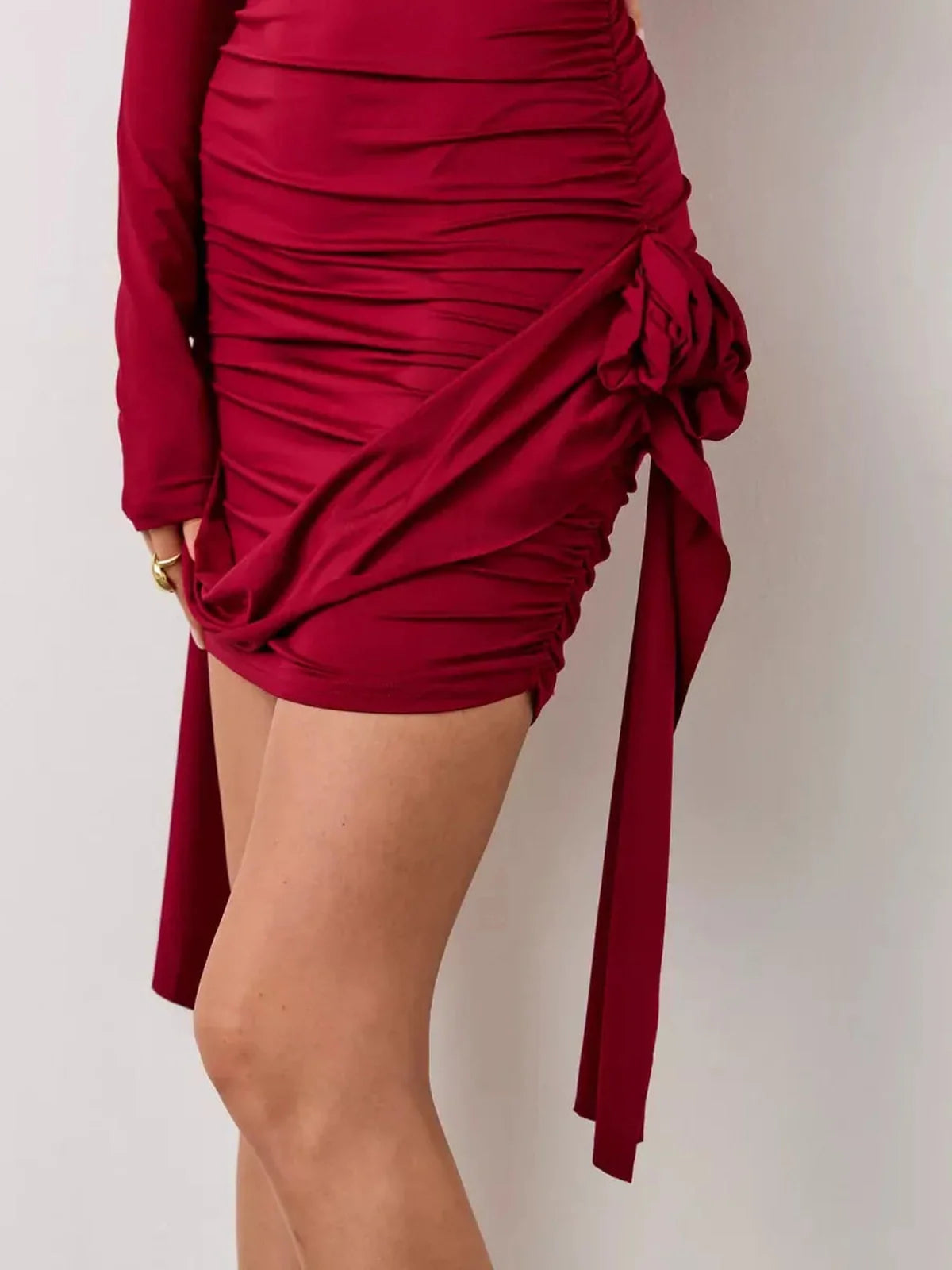 Crimson Bloom red mini dress featuring sculptural ruching and side rosettes, perfect for summer, parties, or weddings.