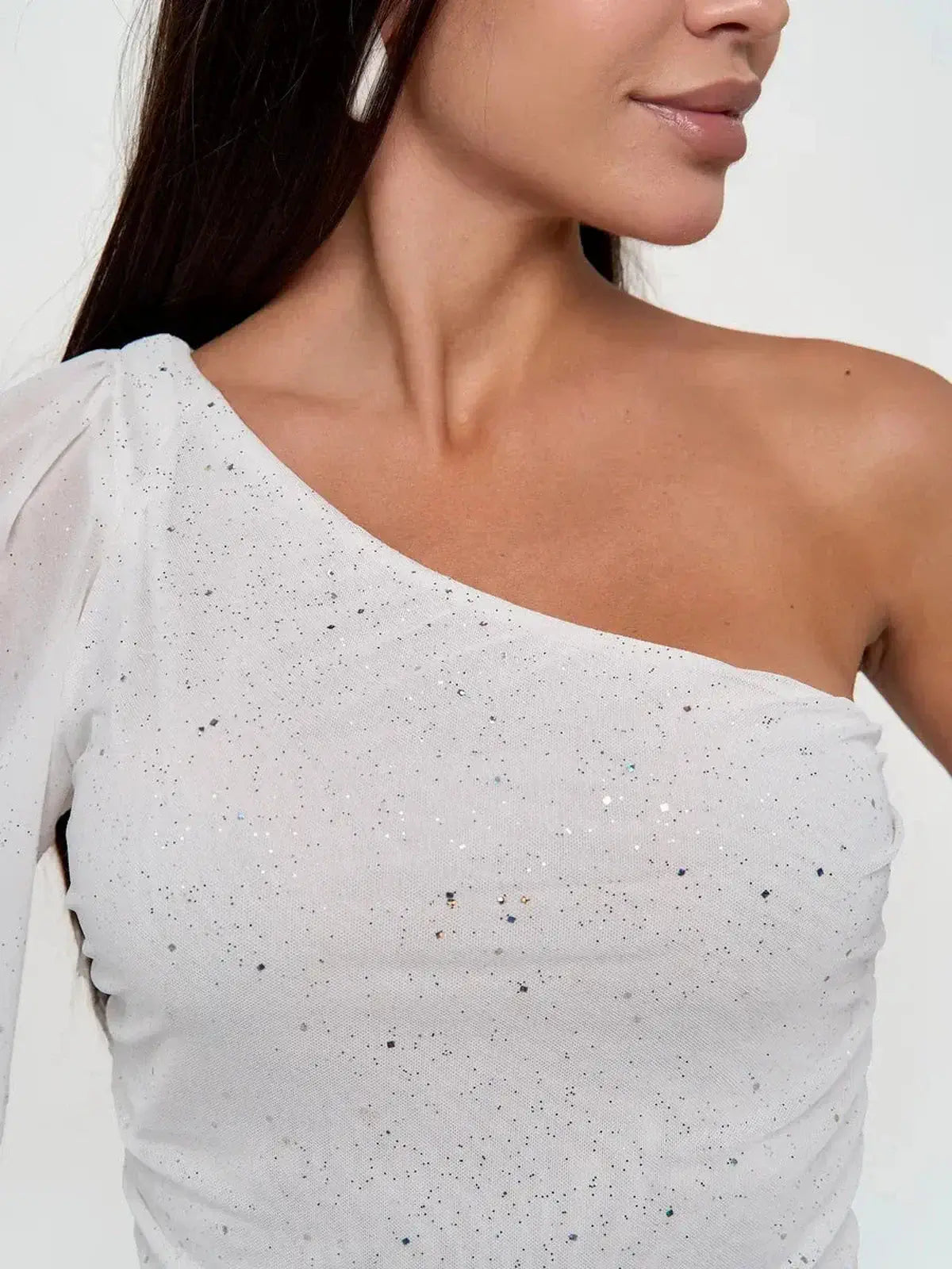 One-shoulder white mini dress with sheer puff sleeve and sparkling sequin details, perfect for evening and formal occasions.