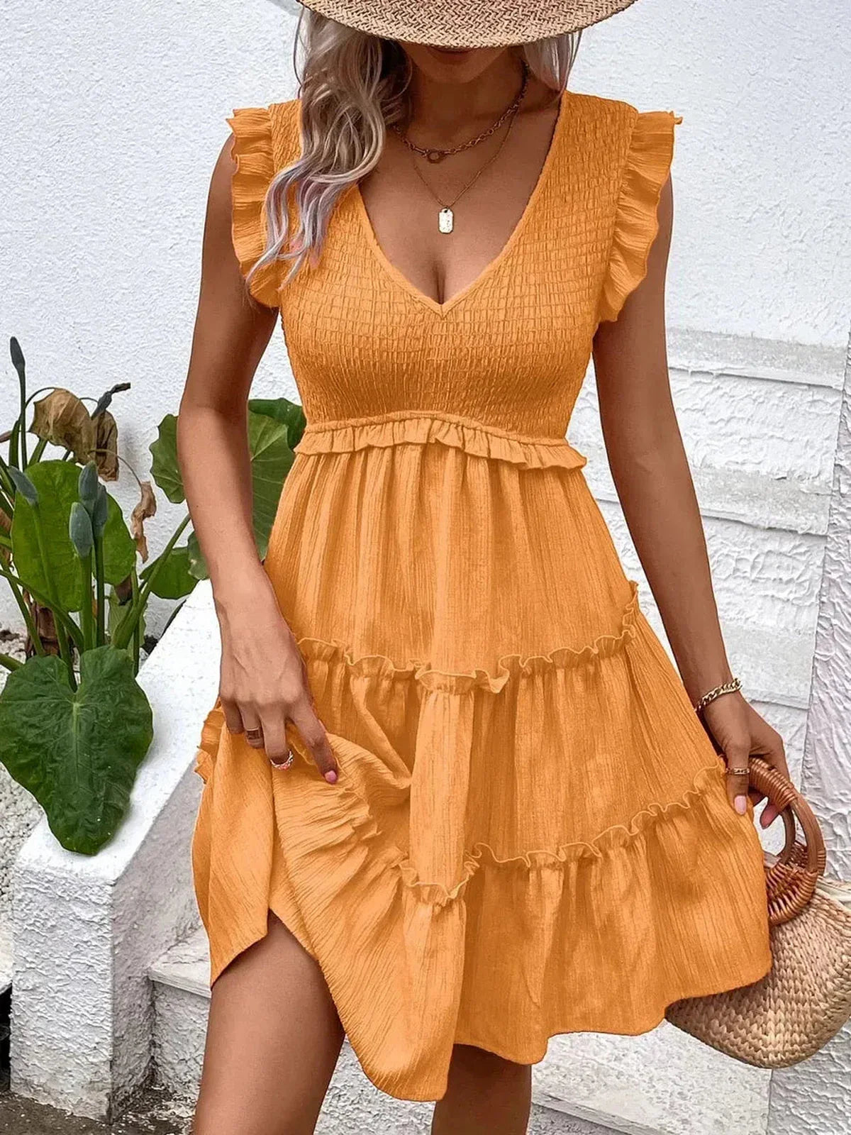 Eden Tier Mini Dress in vibrant orange with ruffle detailing, perfect for summer, weddings, and casual occasions.