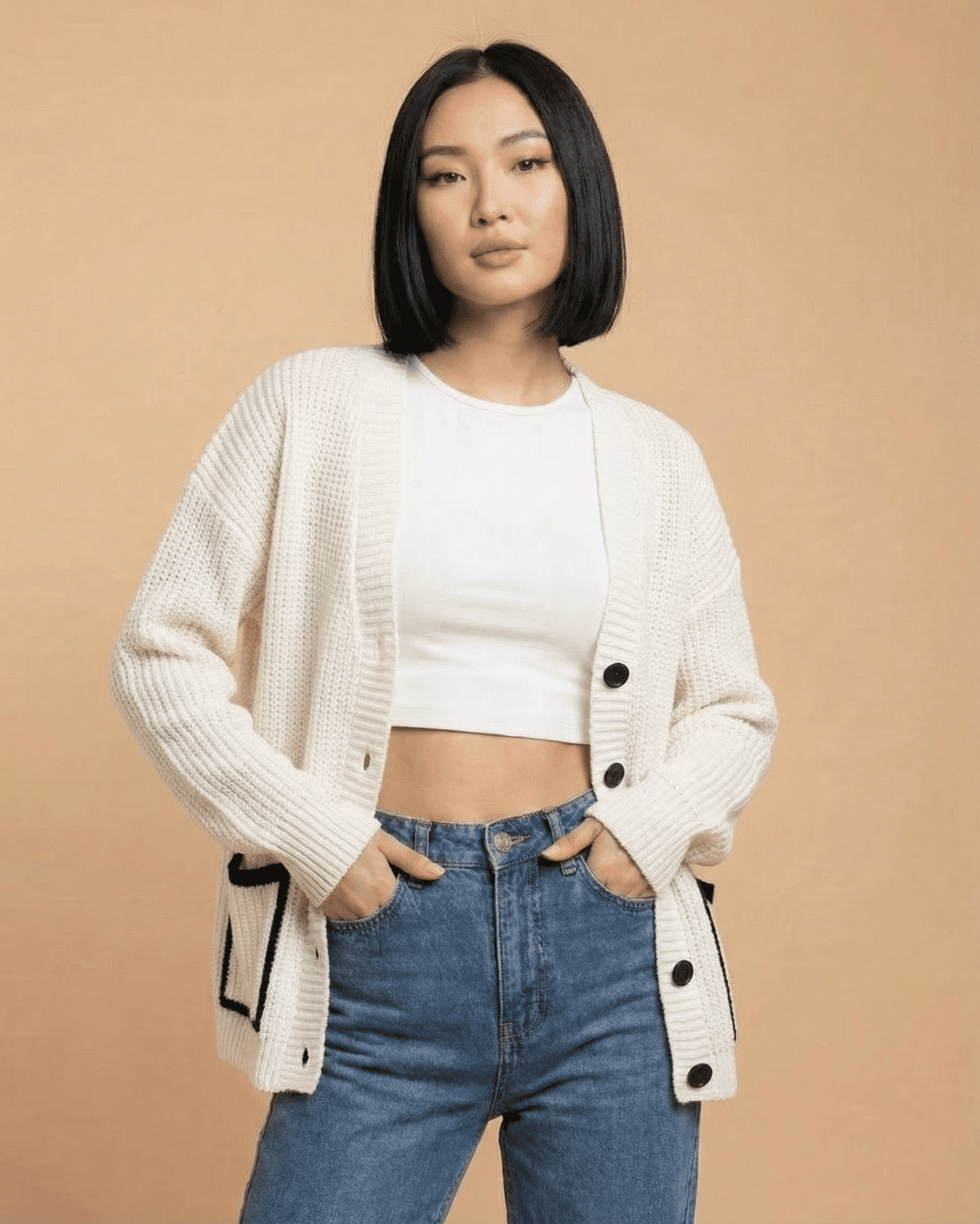 Elara Cardigan by Slimona, a loose fit V-neck color block knit sweater styled with jeans.