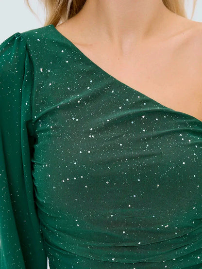 Emerald Spark mini dress with asymmetrical neckline and sheer puff sleeve, embellished with silver sparkles.