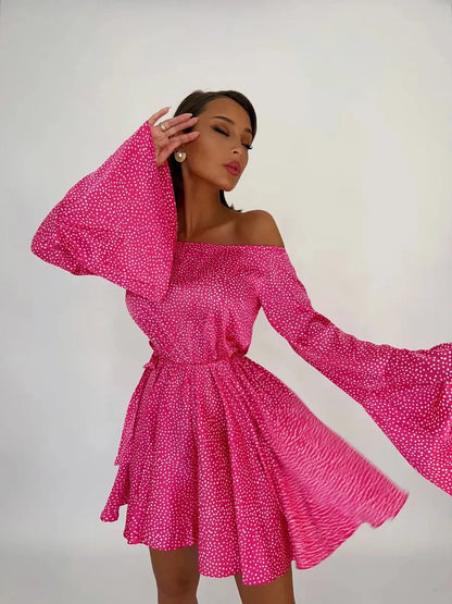 Flirt Pulse Mini Dress in bold pink with white polka dots, featuring off-the-shoulder style and flared sleeves.