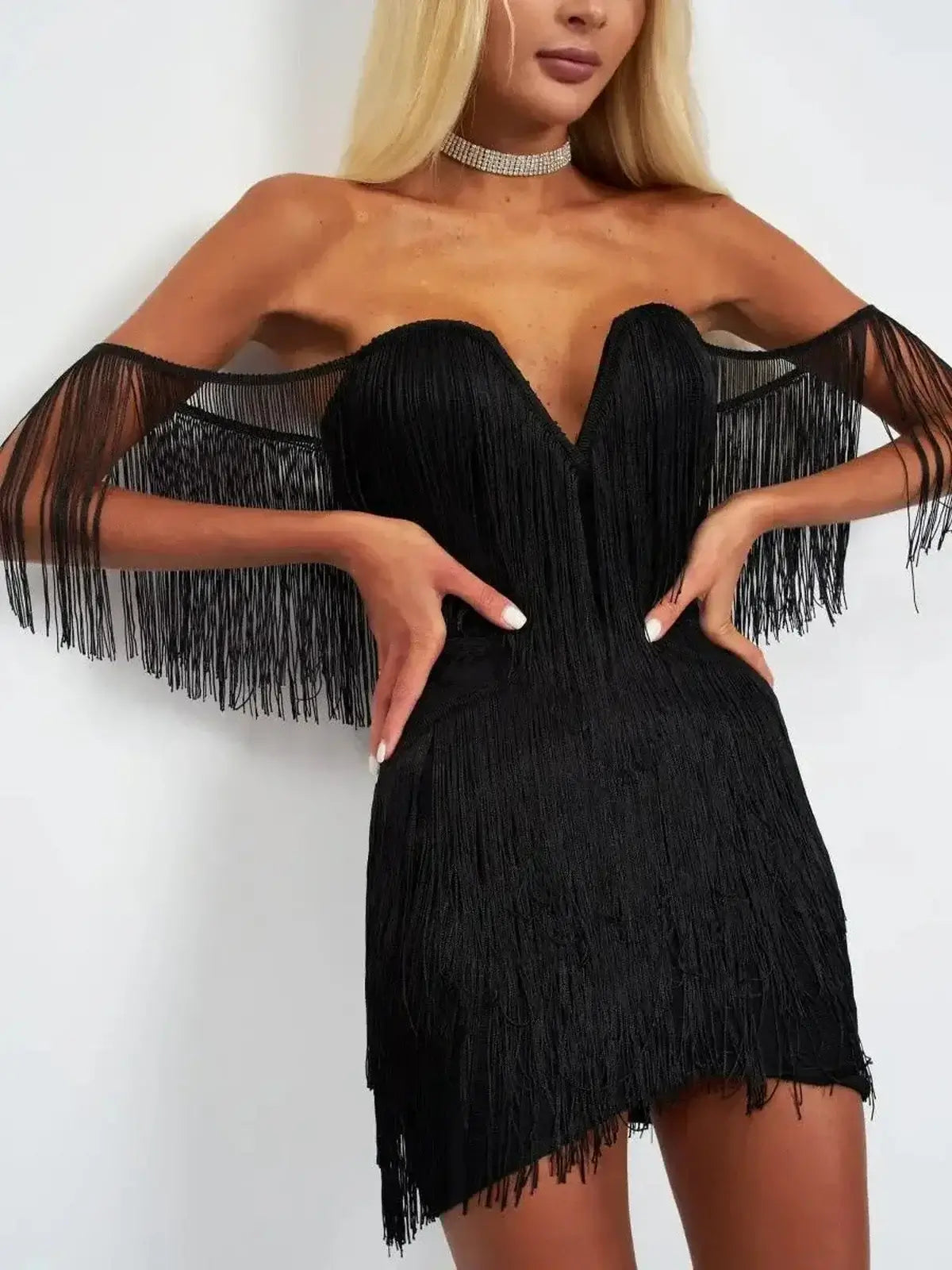Black fringe dress featuring dramatic off-shoulder design and deep V-neckline, perfect for parties and special occasions.