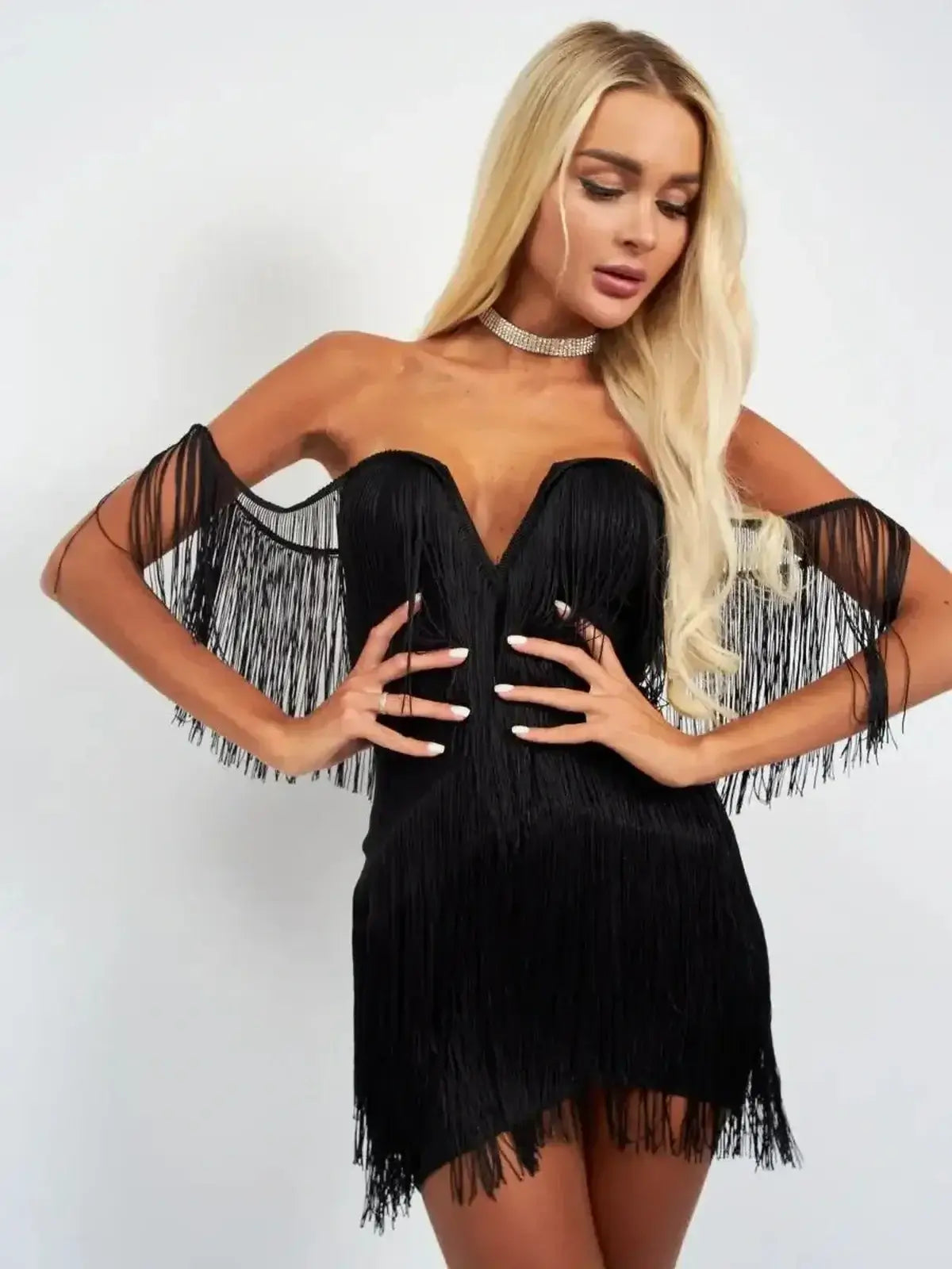 Black mini fringe dress with off-shoulder design and deep V-neckline, perfect for party and cocktail occasions.