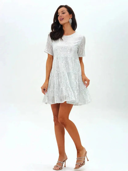 Sparkling white mini dress with short sleeves and tiered hem, perfect for summer parties and weddings.