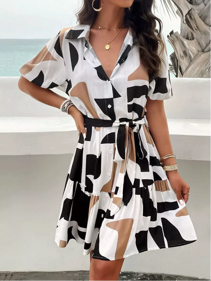 GeoChic Mini Dress featuring a stylish A-line cut, short sleeves, and a self-tie belt with a bold abstract print.