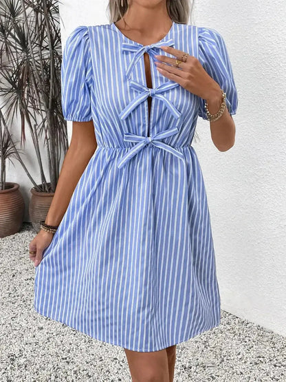 Harbor Stripe Mini Dress featuring a blue and white striped design with bows and puff sleeves, perfect for summer occasions.
