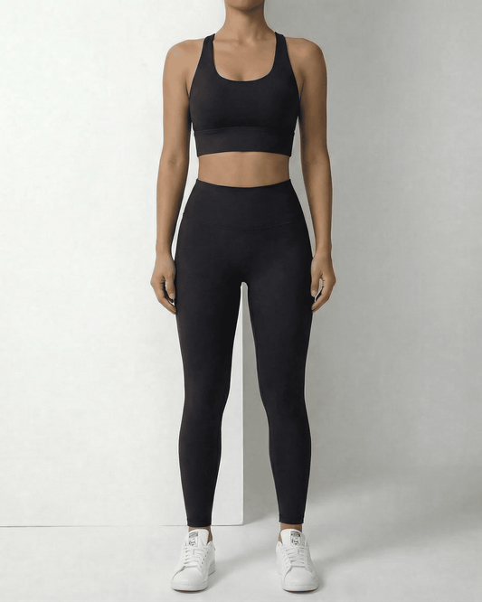 Model wearing Slimona Iris Leggings Black, sleek ankle-length leggings with a complementary black sports bra.