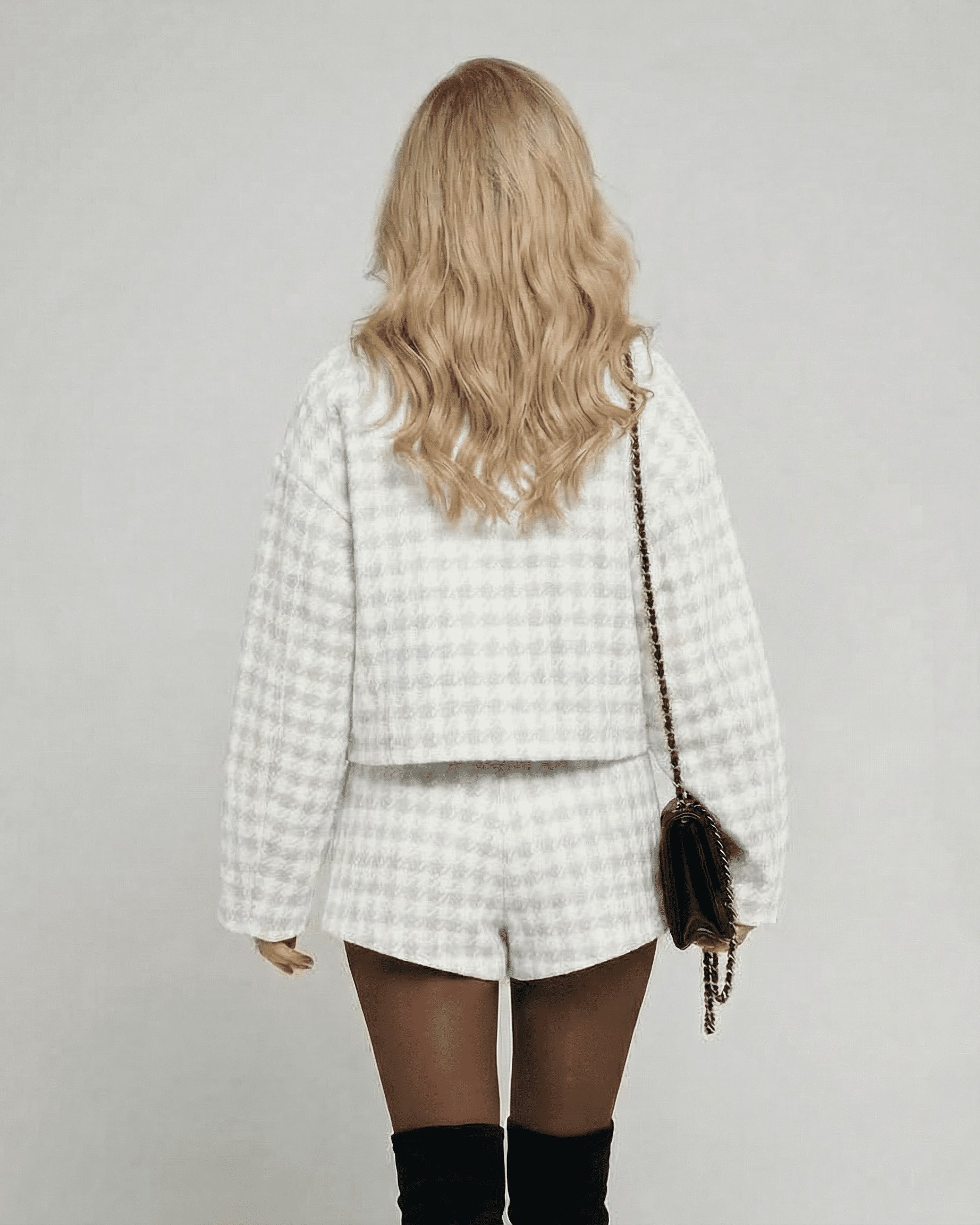 Back view of a model in the Slimona Luna Set, showcasing elegant tailored shorts and a chic long-sleeve top.