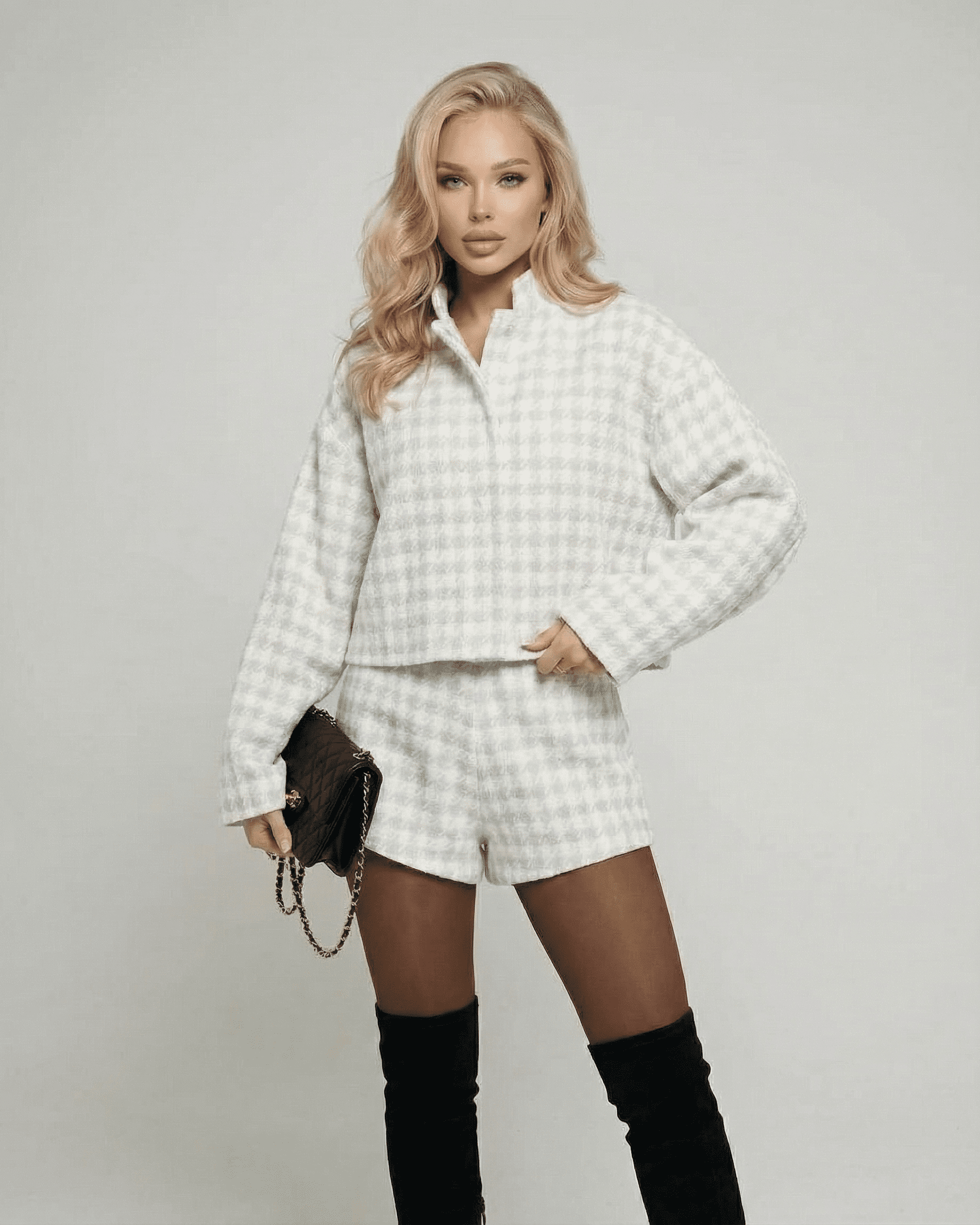 Elegant model wearing the Slimona Luna Set two-piece outfit with tailored shorts and textured long-sleeve top.