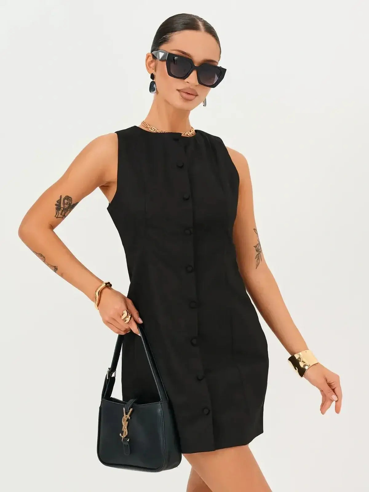 Model wearing the Icon Edge Mini Dress, a sleek black sleeveless dress with buttons, perfect for summer or cocktail events.