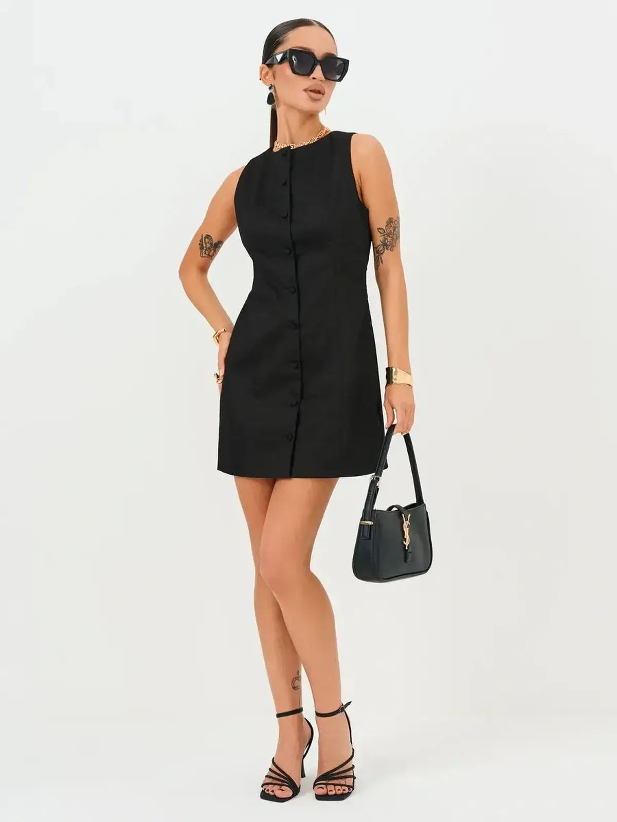 Elegant black mini dress with button detail, ideal for summer weddings, parties, or formal occasions.