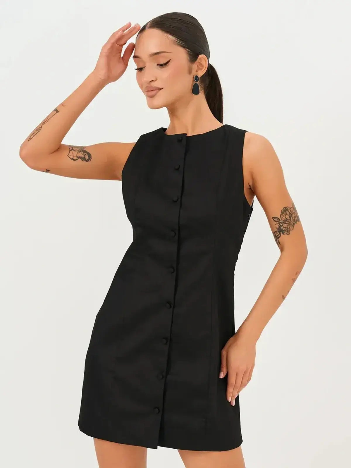 Sleeveless Icon Edge Mini Dress in sleek black with round neckline and front button detail, perfect for weddings and parties.