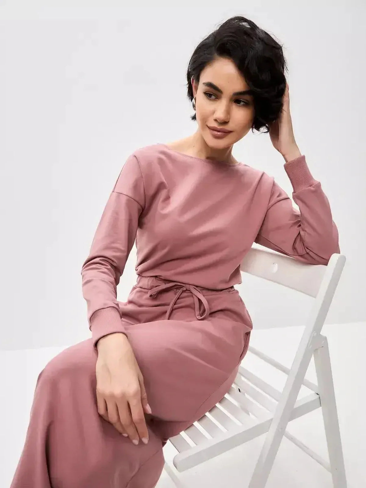 Model wearing the Blush Lounge Maxi Dress in dusty pink, showcasing its elegant boat neckline and adjustable waist.