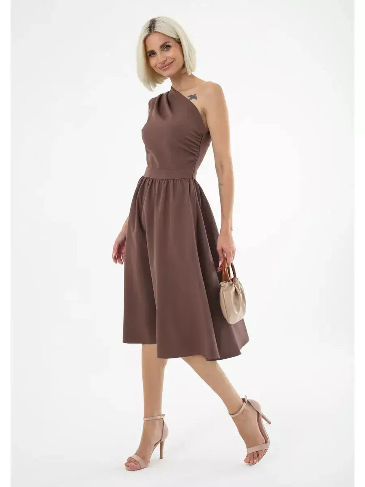 Chic one-shoulder Solace Midi Dress in chocolate brown, perfect for weddings and summer parties, styled with elegant accessories.