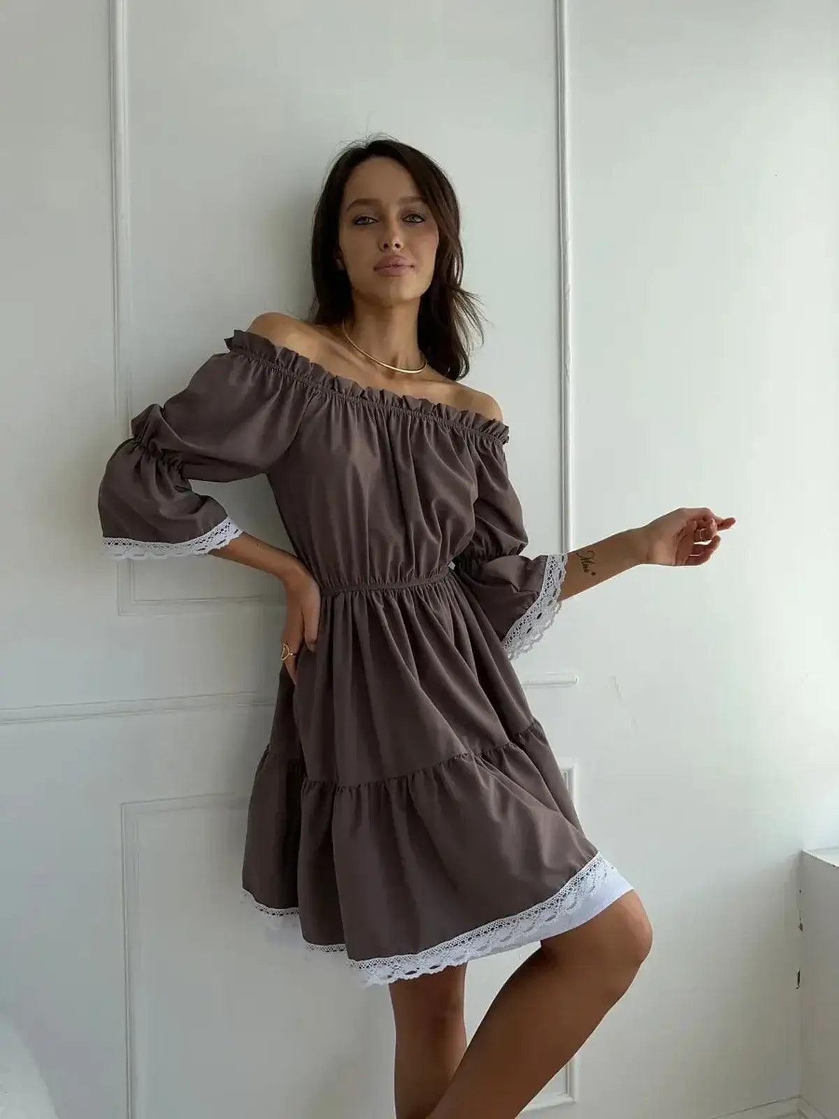 Off-shoulder mocha brown mini dress with white lace trim, perfect for summer weddings and casual outings.
