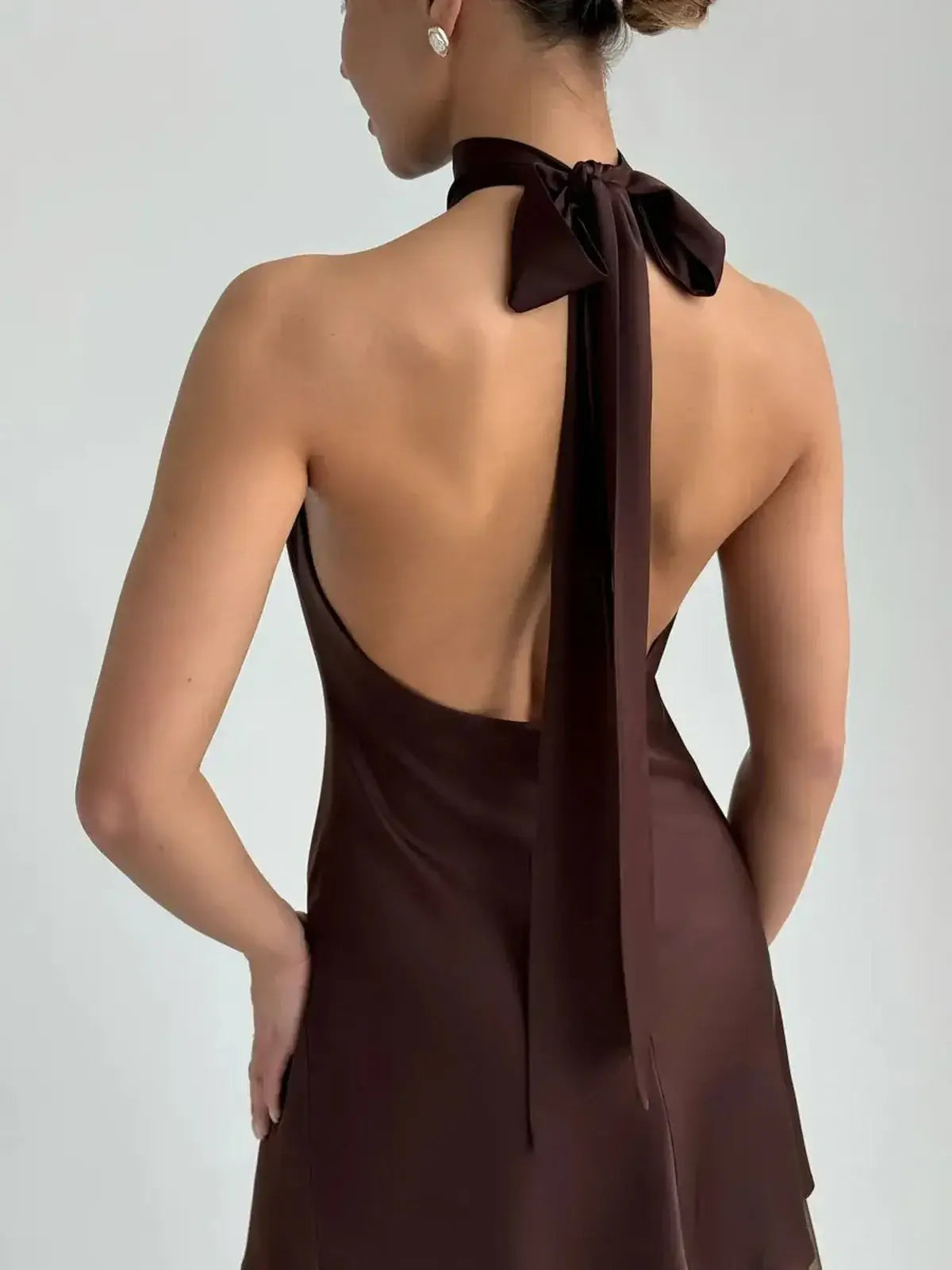 Mocha Silk Mini dress showcasing a refined halter neckline and sculptural bow tie, perfect for wedding guest or prom.