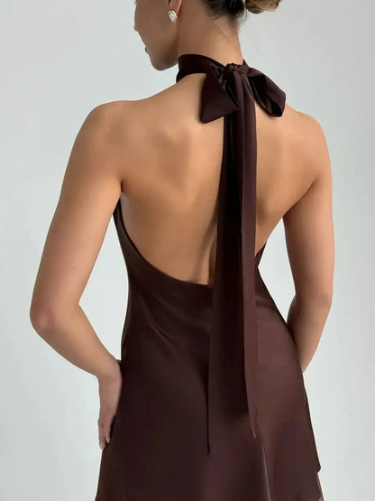 Mocha Silk Mini dress showcasing a refined halter neckline and sculptural bow tie, perfect for wedding guest or prom.