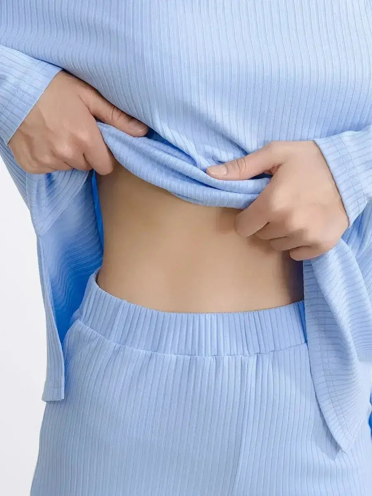 Close-up of a model in a light blue ribbed knit lounge set, showcasing comfort and style.