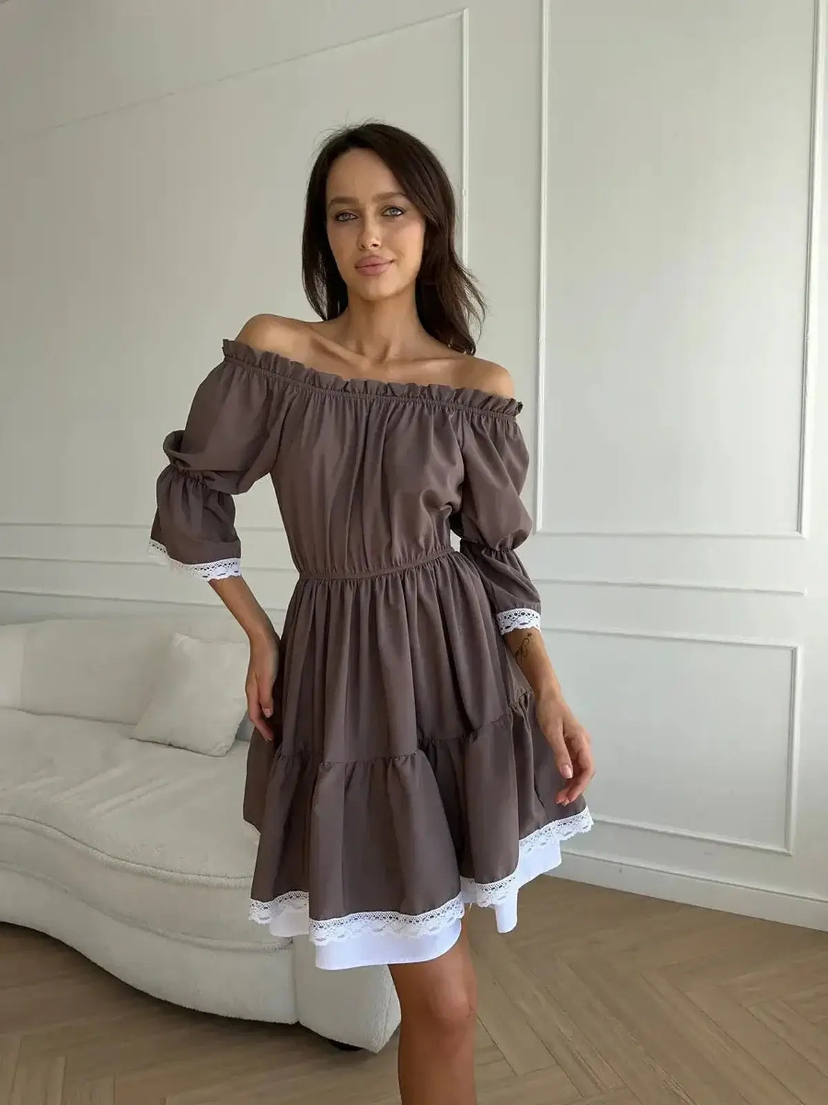 Mocha Muse off-shoulder mini dress with white ruffle trim, perfect for summer weddings and casual outings.