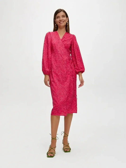 Vibrant pink Confetti Bloom Midi Dress in a wrap silhouette, perfect for weddings and summer parties.