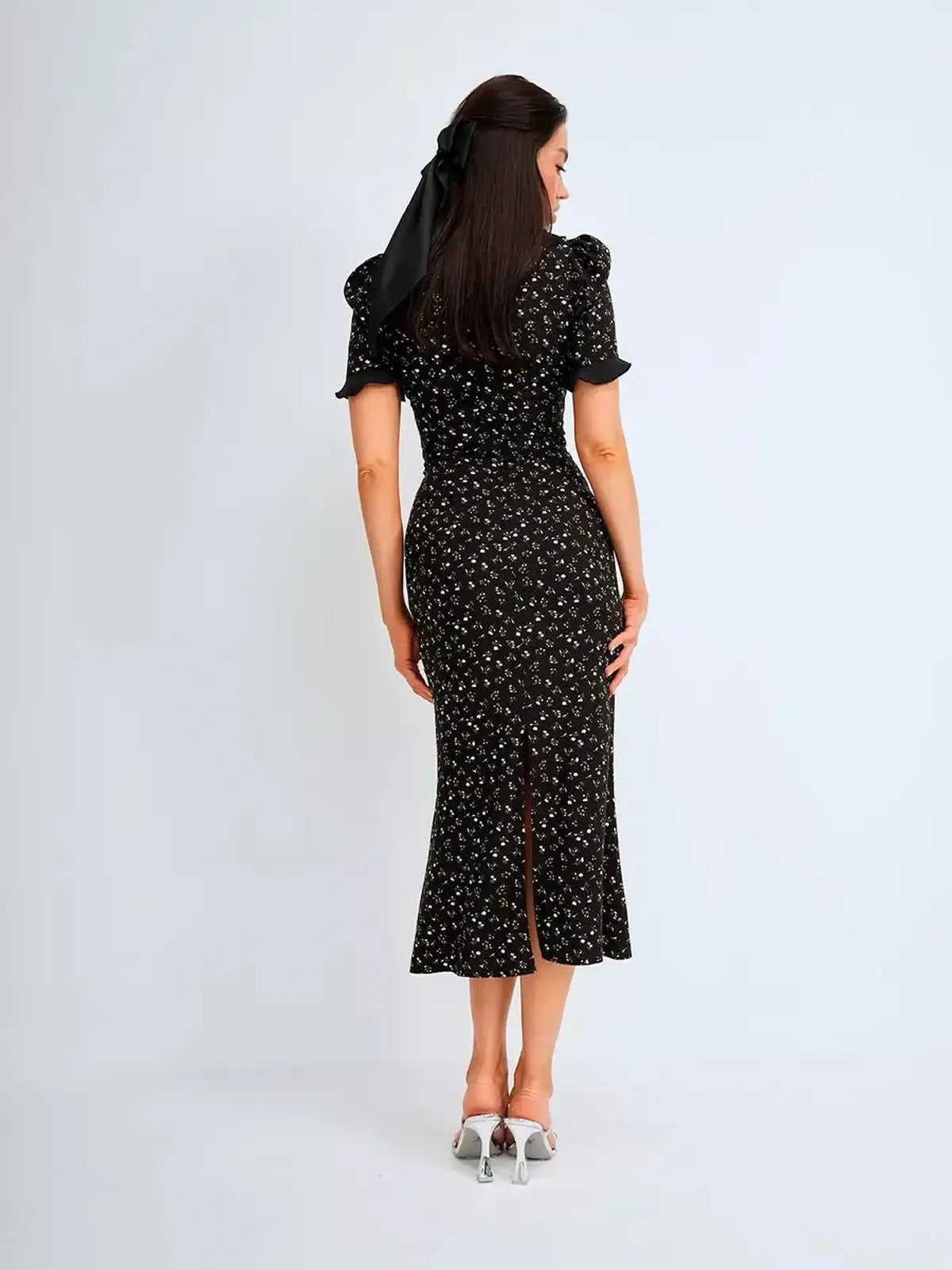 Elegant midi dress with floral print, ruffle details, and a fitted silhouette, perfect for weddings and special occasions.