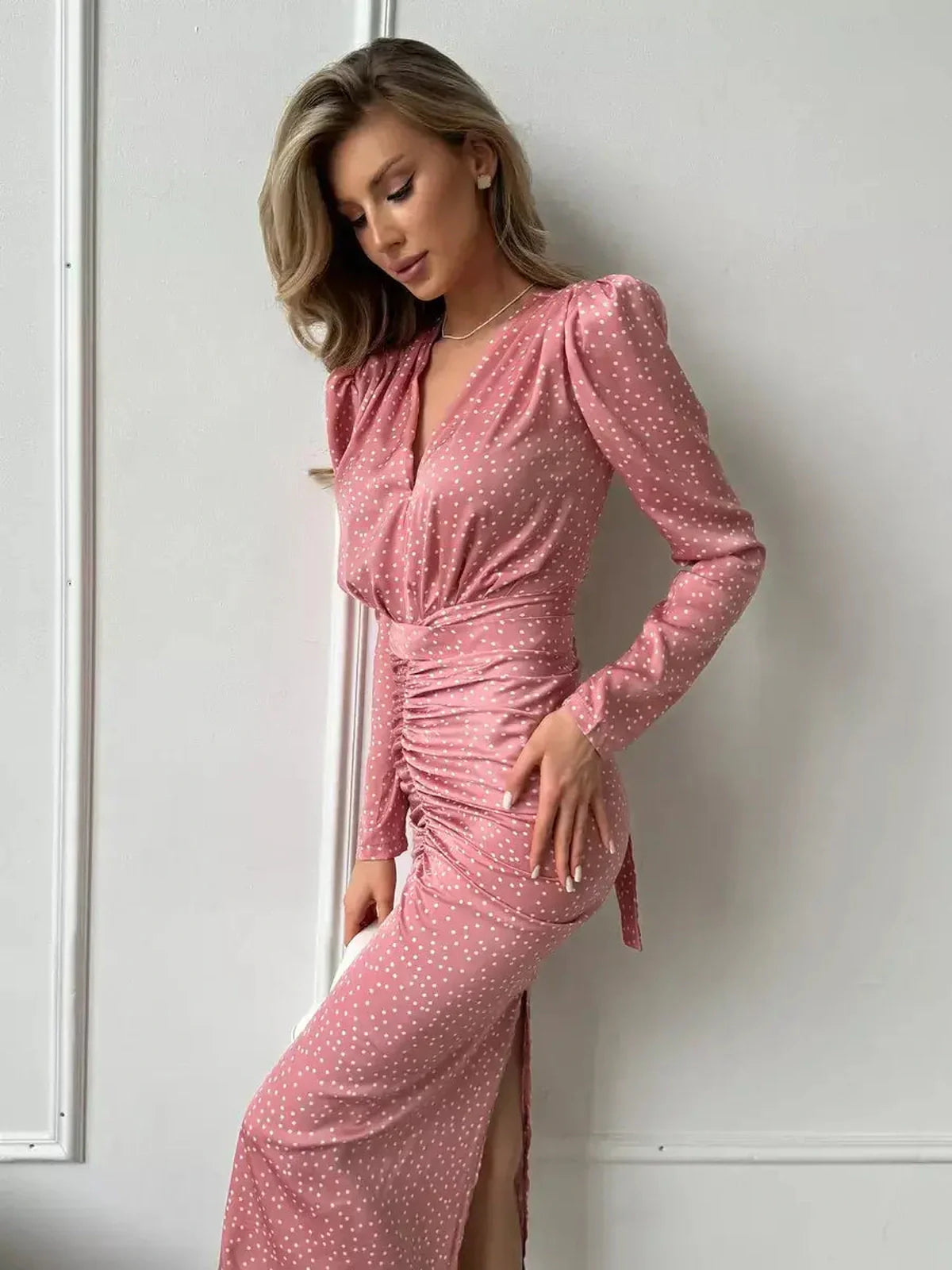 Grace Drape Midi Dress in pink polka dots, featuring a flattering V-neckline and gathered ruching for a chic look.