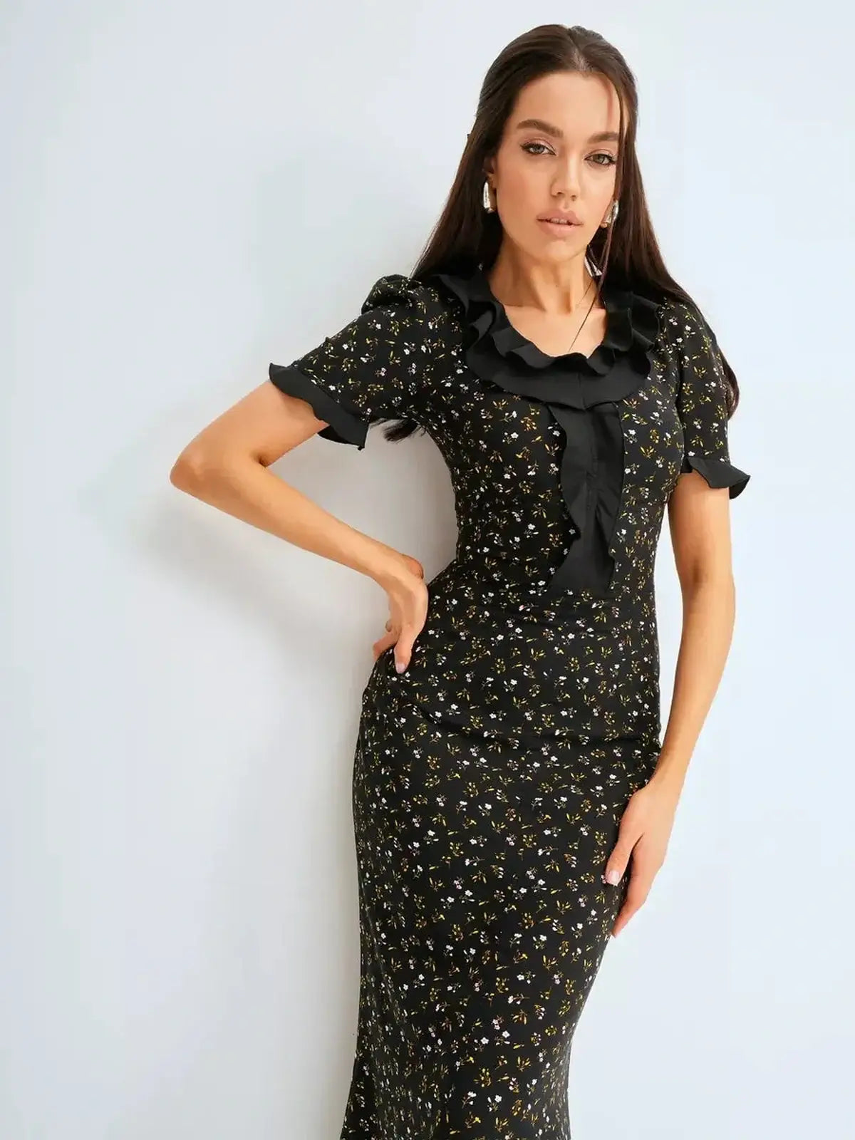 Elegant black midi dress with floral prints and ruffle details, perfect for weddings and formal occasions.