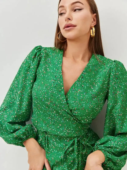 Elegant green midi dress featuring a wrap design and speckled dot print, perfect for summer and wedding guest attire.