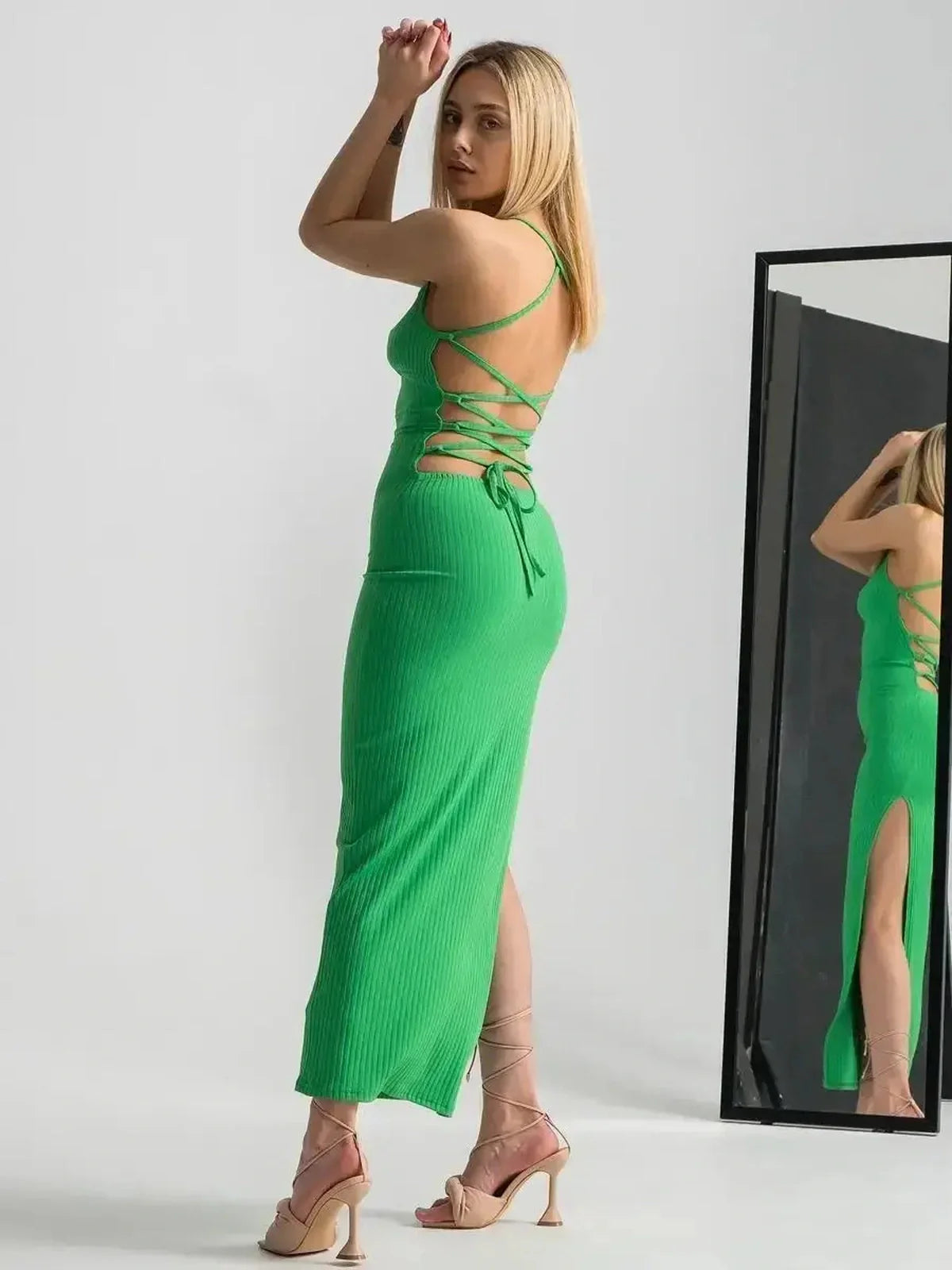 Maxi Dress Emerald Whisper in bold green with a strappy back and dramatic leg slit, perfect for summer events and elegant occasions.