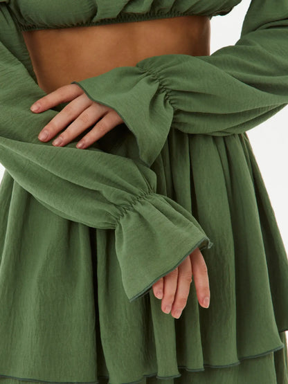 Detail of the tiered ruffle set showcasing flowy sleeves and soft green fabric, ideal for summer dresses or casual wear.