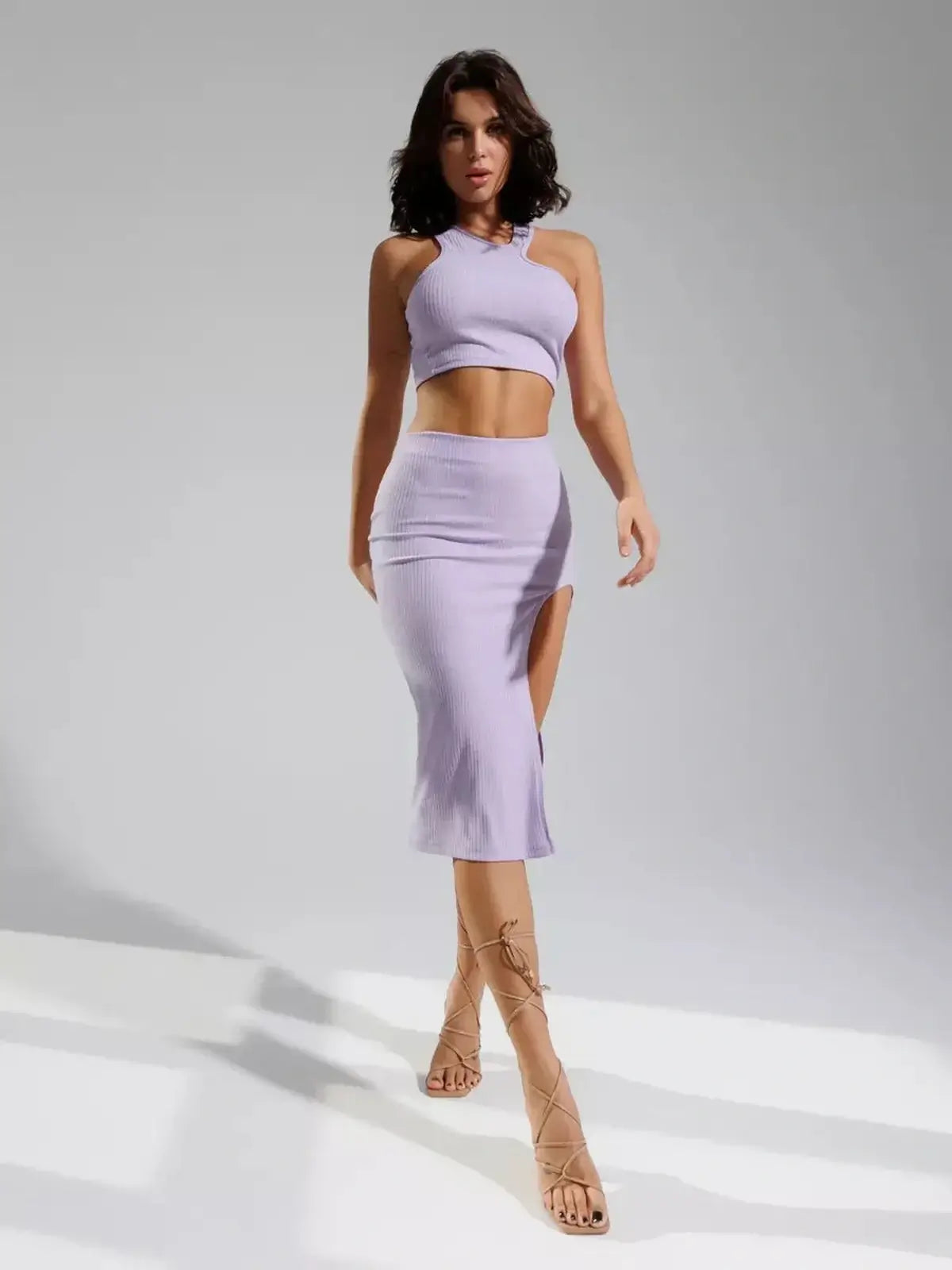 Lilac cutout matching set featuring a ribbed knit crop top and high-waisted skirt with a thigh-high slit.