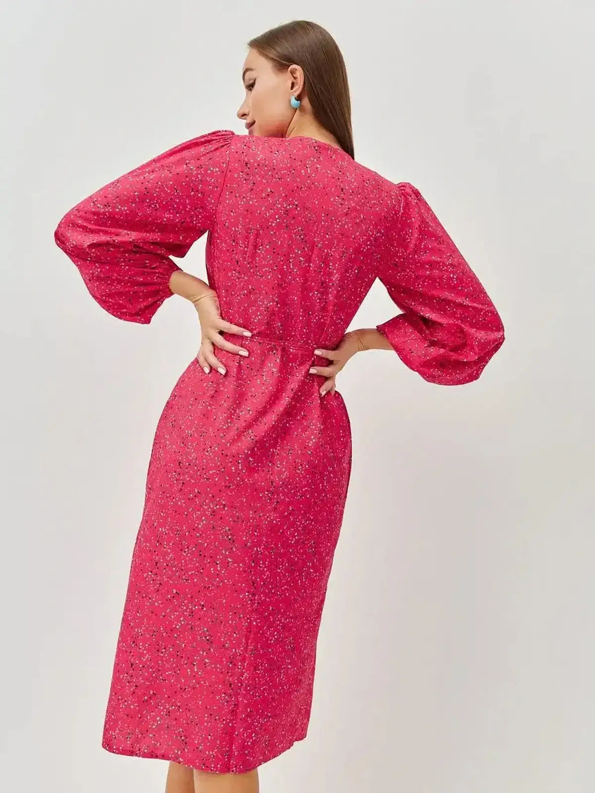 Back view of the vibrant pink Confetti Bloom Midi Dress featuring elegant puff sleeves and a playful floral print.