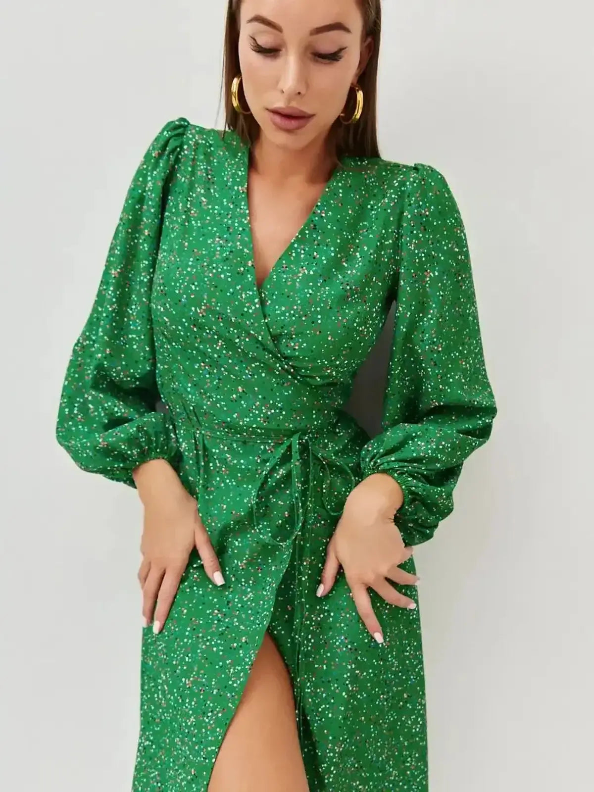 Elegant green midi dress with speckled pattern and wrap design, perfect for summer weddings and events.