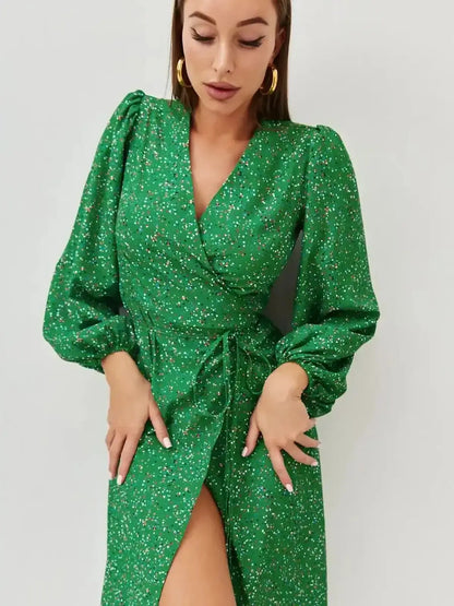 Elegant green midi dress with speckled pattern and wrap design, perfect for summer weddings and events.
