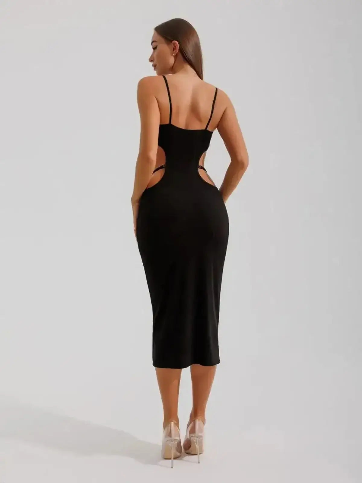 Back view of a black midi dress featuring cutouts and a body-hugging fit, perfect for weddings or formal events.