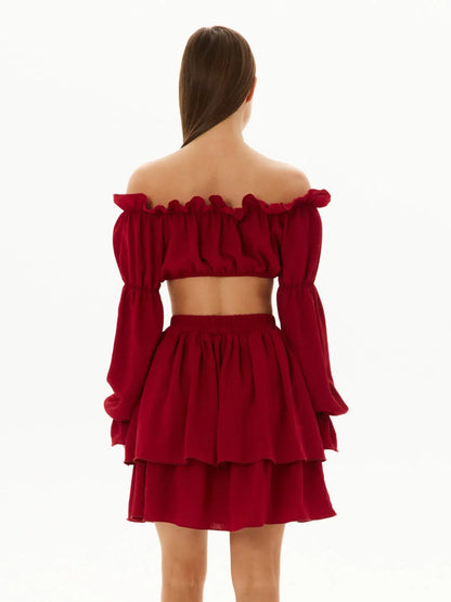 Back view of a ruffle summer set in red featuring an off-shoulder crop top and layered mini skirt, perfect for summer events.