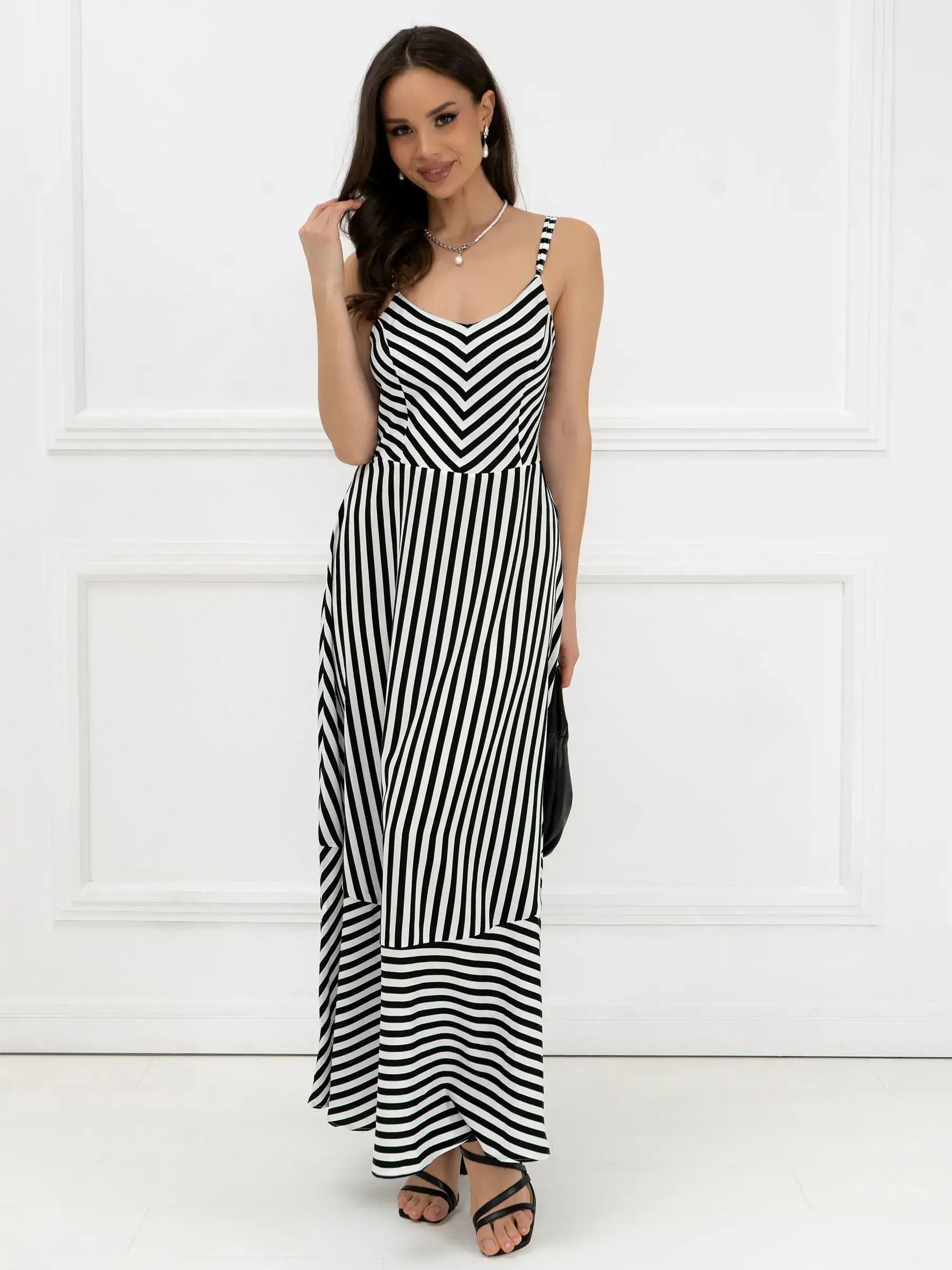 Black and white striped maxi dress, perfect for summer weddings or casual outings, showcasing elegant lines and comfort.