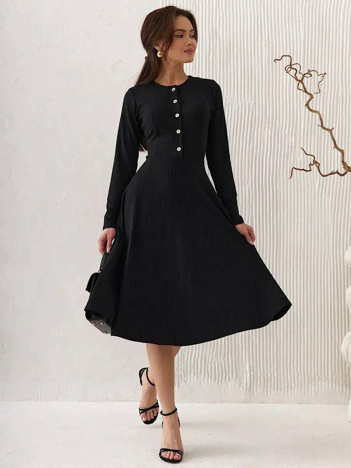 Serene Grace Midi Dress in black ribbed fabric, featuring decorative buttons and a flared skirt, ideal for formal or casual occasions.