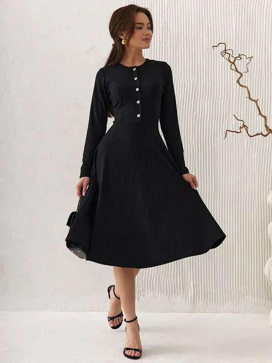 Serene Grace Midi Dress in black ribbed fabric, featuring decorative buttons and a flared skirt, ideal for formal or casual occasions.