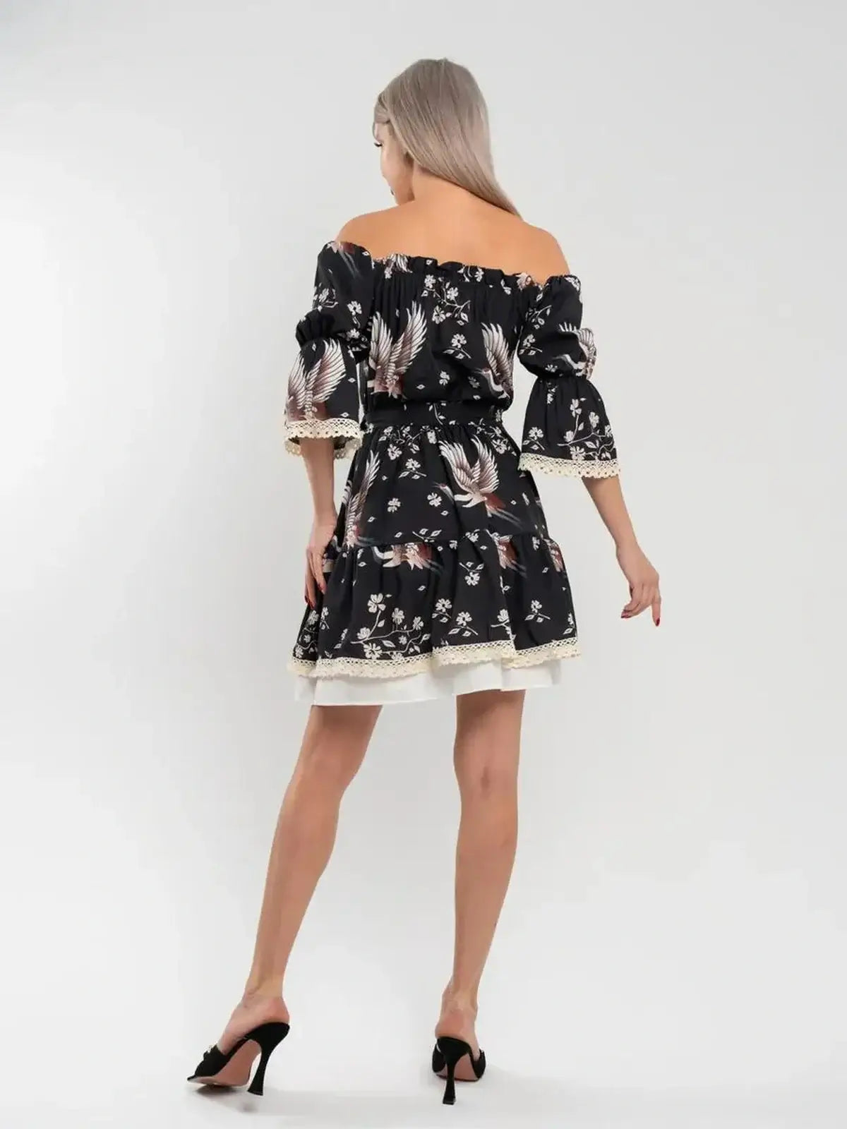 Back view of Crane Bloom mini dress featuring a floral print and off-shoulder design, perfect for summer occasions.