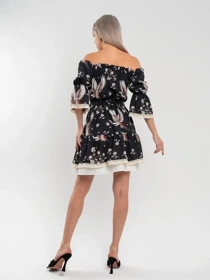 Back view of Crane Bloom mini dress featuring a floral print and off-shoulder design, perfect for summer occasions.