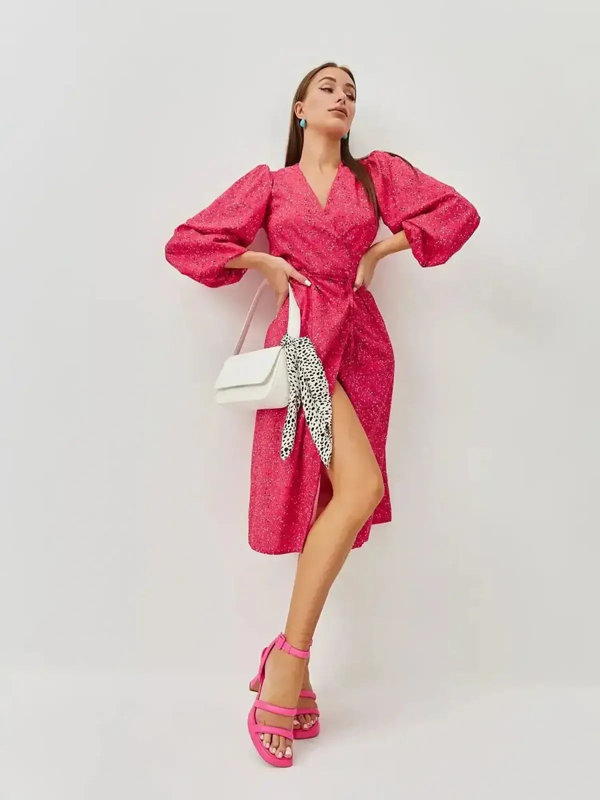 Vibrant pink midi dress with wrap silhouette and playful print, perfect for weddings and summer events.