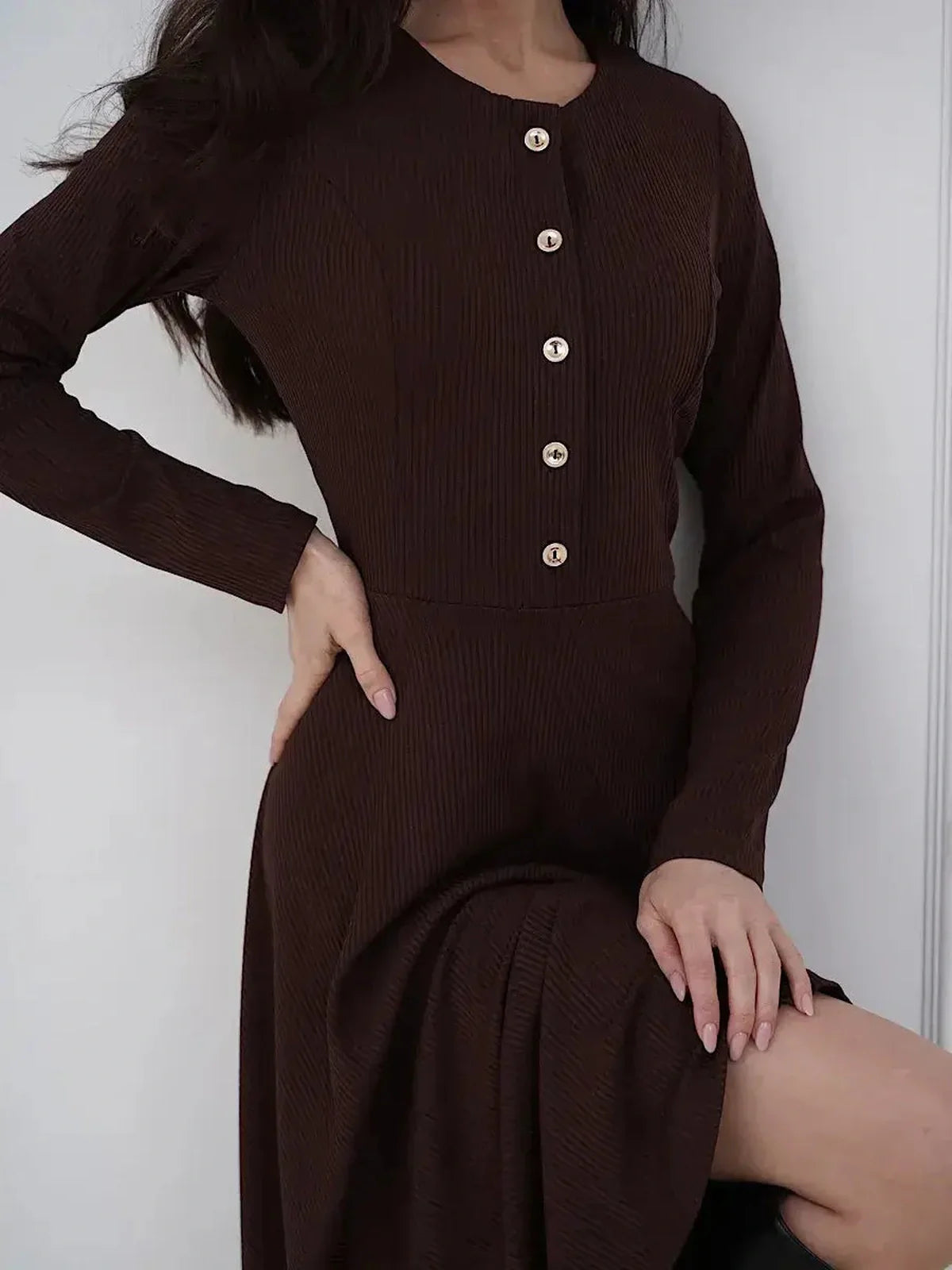 Elegant brown midi dress featuring button detailing and a flattering fit-and-flare silhouette, ideal for various occasions.