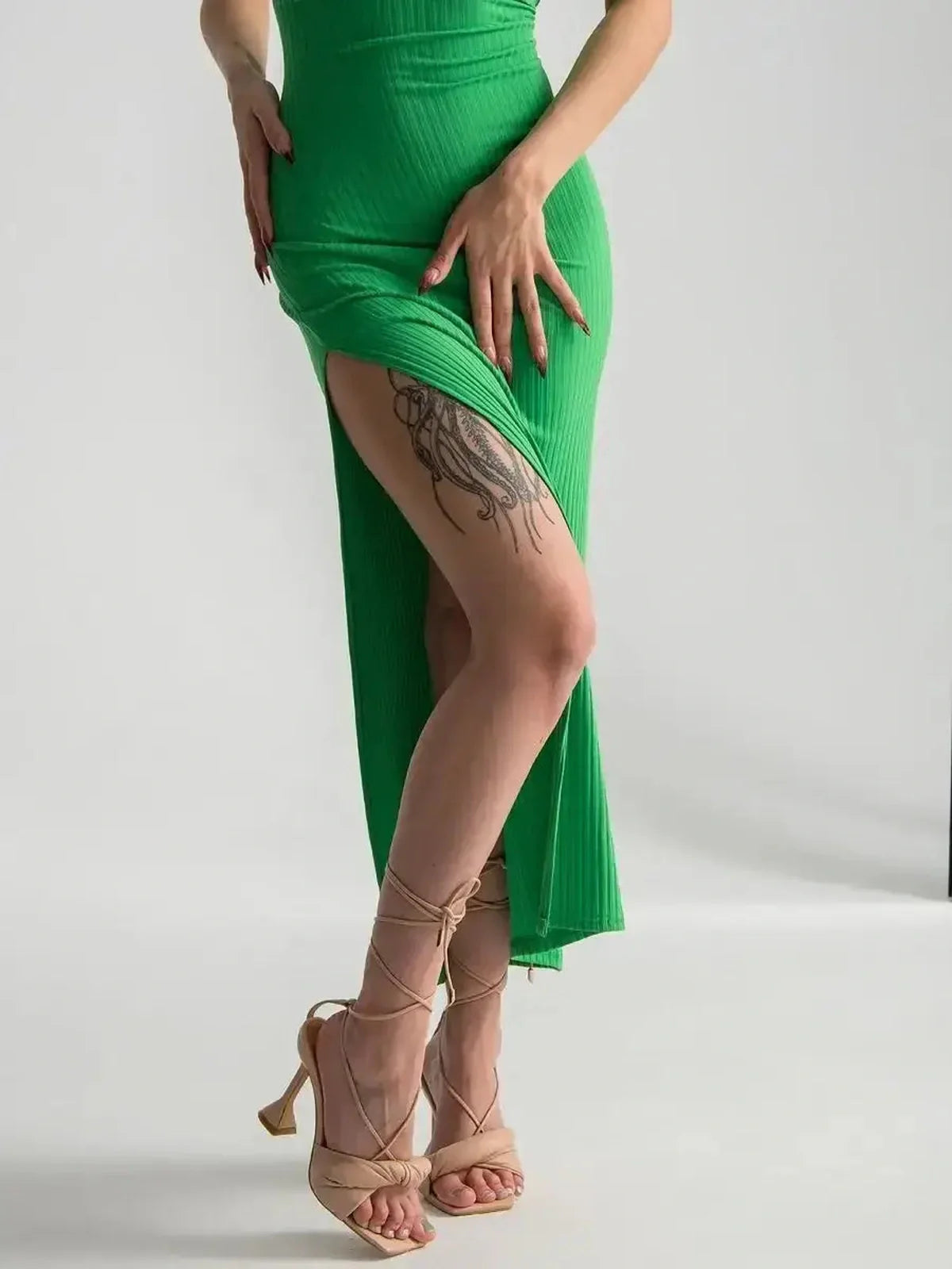 Elegant Maxi Dress Emerald Whisper in vibrant green with a dramatic side slit, perfect for summer events and weddings.