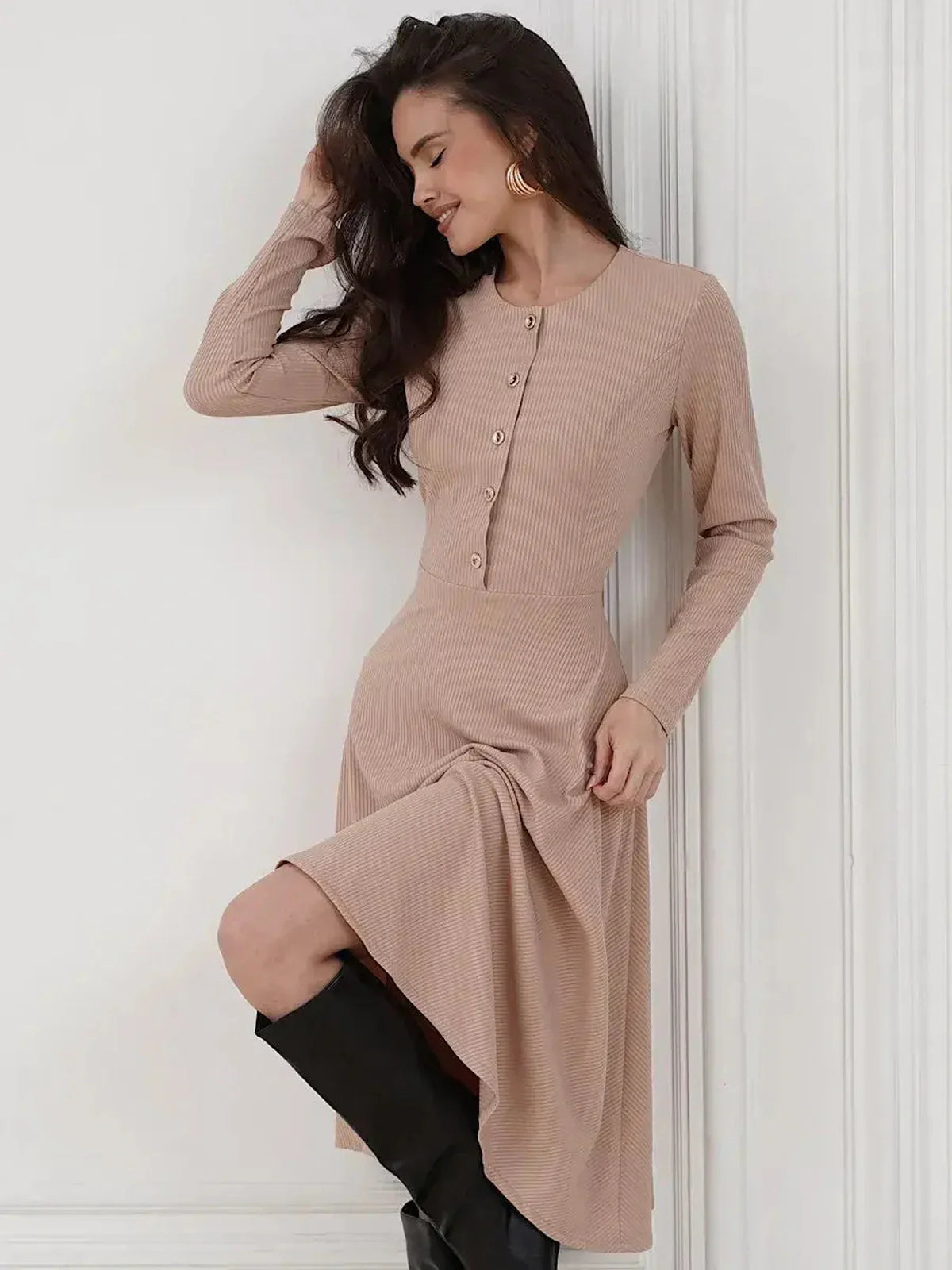 Stylish woman in a beige ribbed midi dress with button details, perfect for summer, weddings, or casual outings.