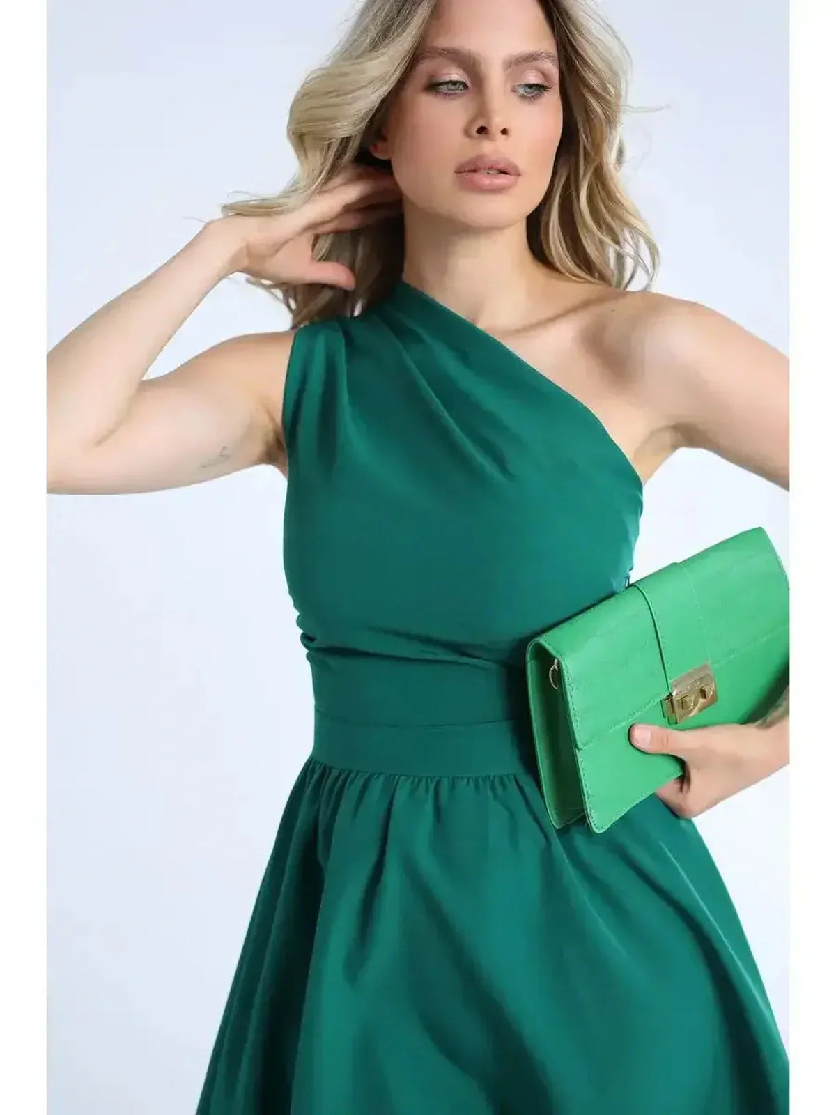 Emerald Grace Midi Dress: One-shoulder elegance, perfect for weddings and special occasions, paired with a stylish green clutch.
