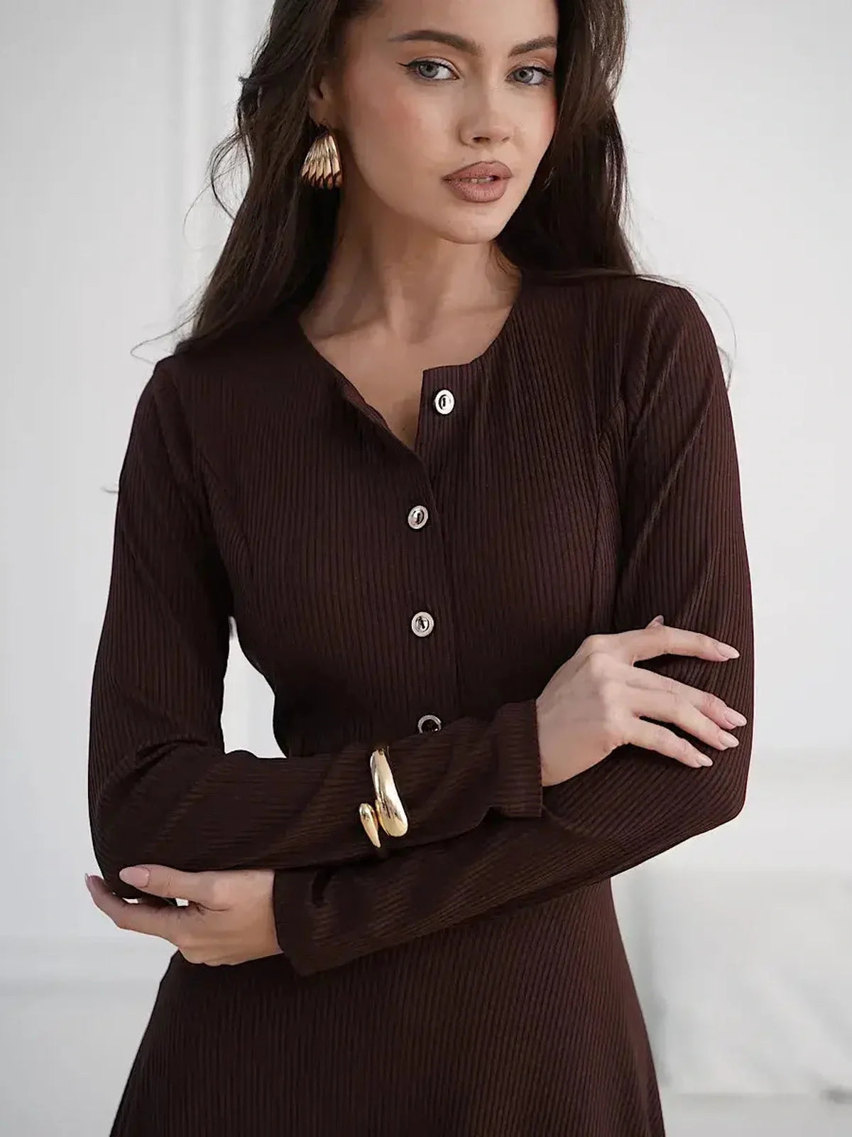 Elegant brown midi dress featuring button detailing and a flattering silhouette, ideal for various occasions.