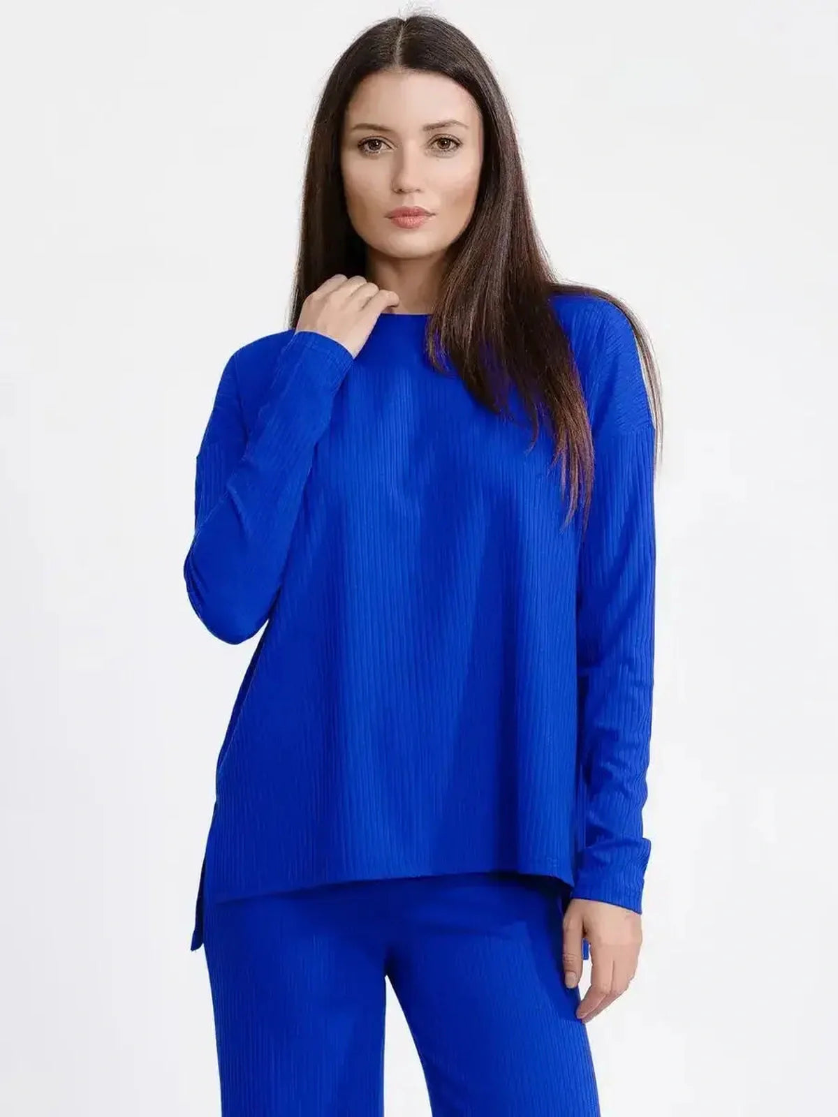 Model wearing an electric blue oversized ribbed knit lounge set, showcasing relaxed elegance and cozy tailoring.