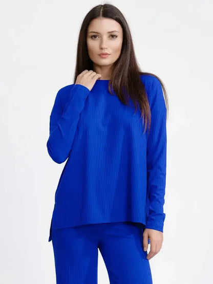 Model wearing an electric blue oversized ribbed knit lounge set, showcasing relaxed elegance and cozy tailoring.